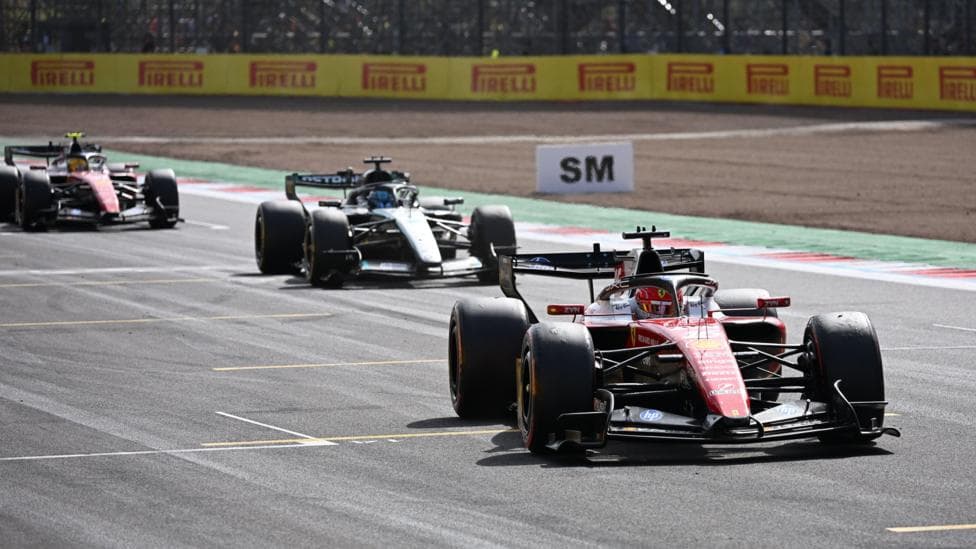 Ferrari's Charles Leclerc crosses the line to win the British Grand Prix with Mercedes George Russell and Ferrari's Lewis Hamilton behind him