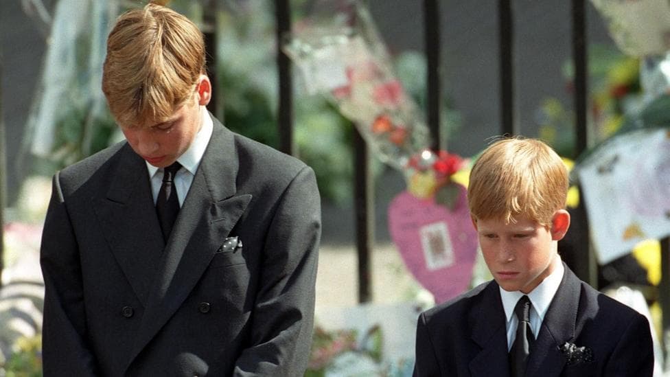 Prince William and Prince Harry bow their heads as their mother's coffin leaves her funeral service