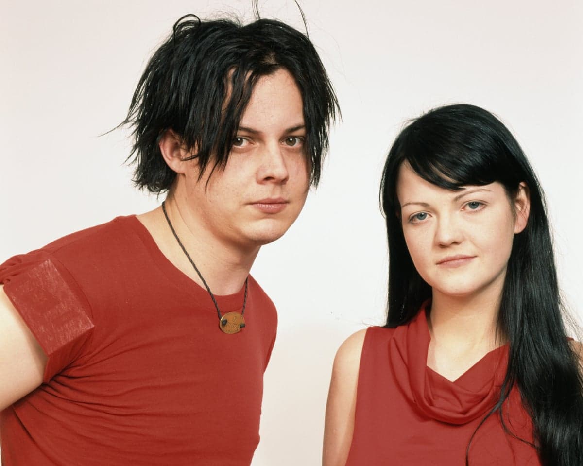 a man and a woman in red tops pose for a photo