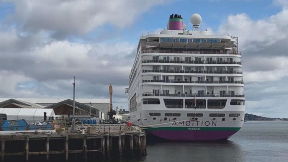 MS Ambition cruise ship sits docked in a body of water