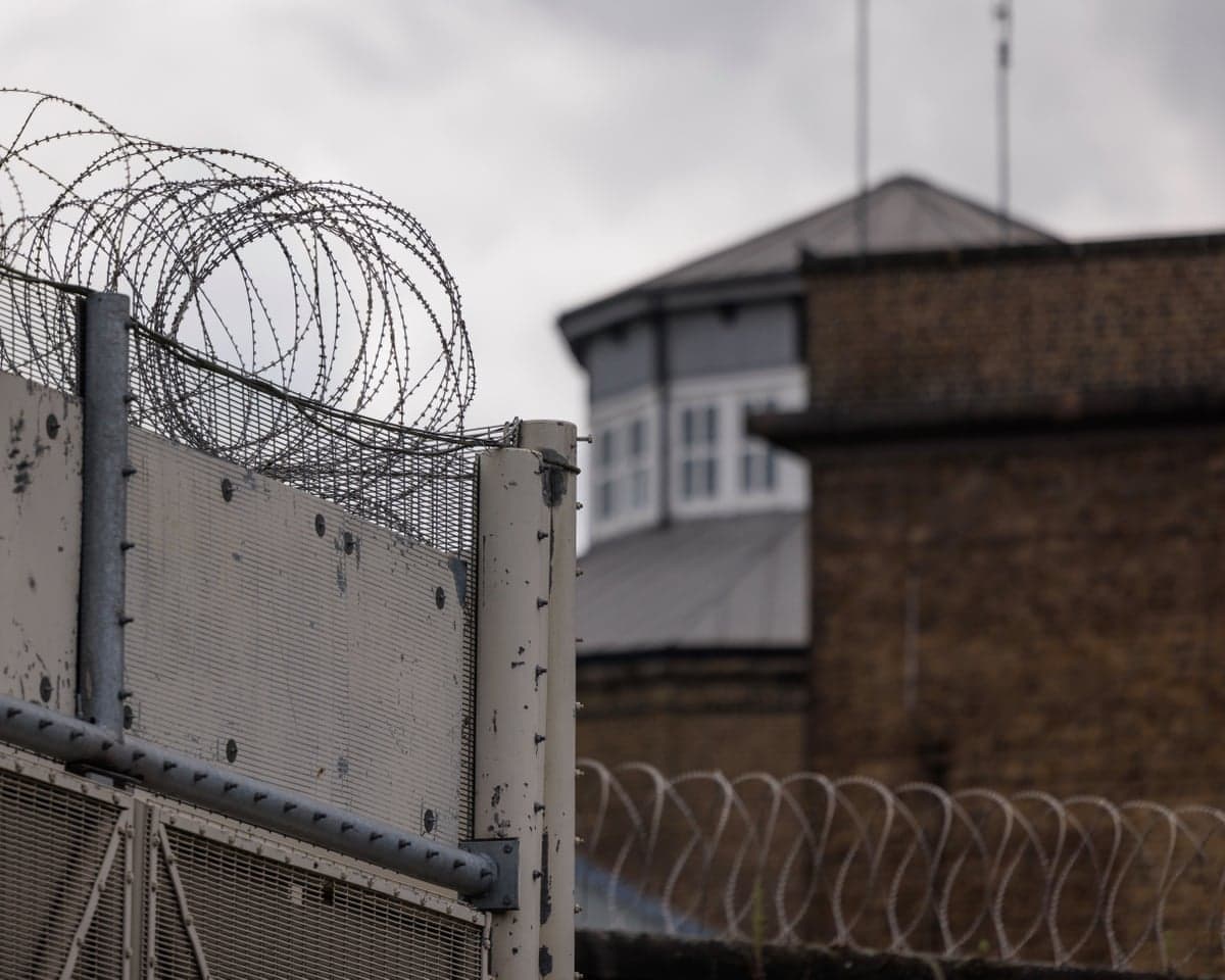 Walls and razor wire at a prison boundary