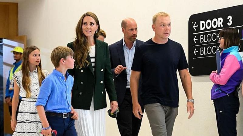 Sir Chris Hoy is pictured walking out of the Sir Chris Hoy velodrome with the Wales family - Prince William, Princess Catherine and their children George, Charlotte and Louis at the Glasgow Commonwealth Games.