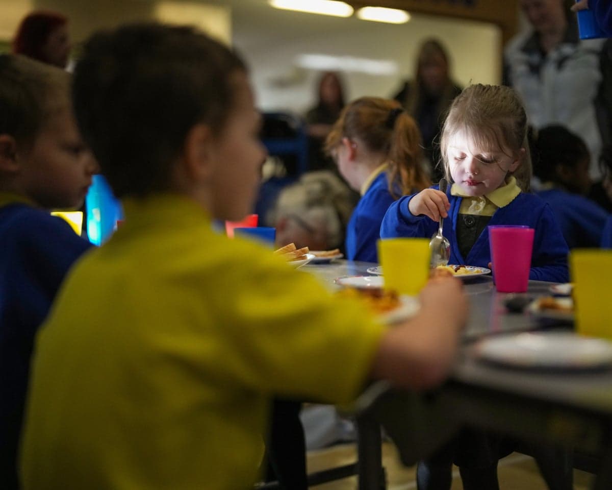 A child eats at a breakfast club at a primary school in Burnley, Lancashire