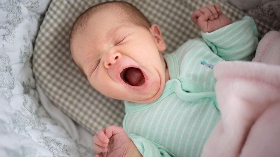 A baby is yawning