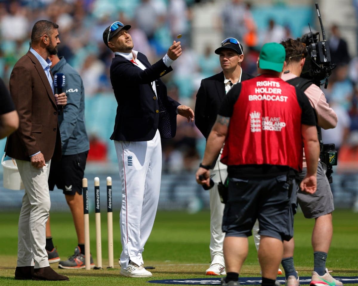Joe Root, England captain, flicks a coin into the air at the pre-match toss