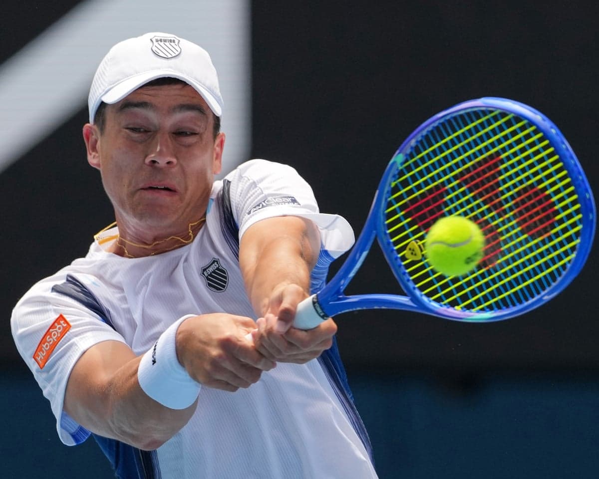 Mackenzie McDonald plays a return to Alex de Minaur during their first round match at the 2026 Australian Open.