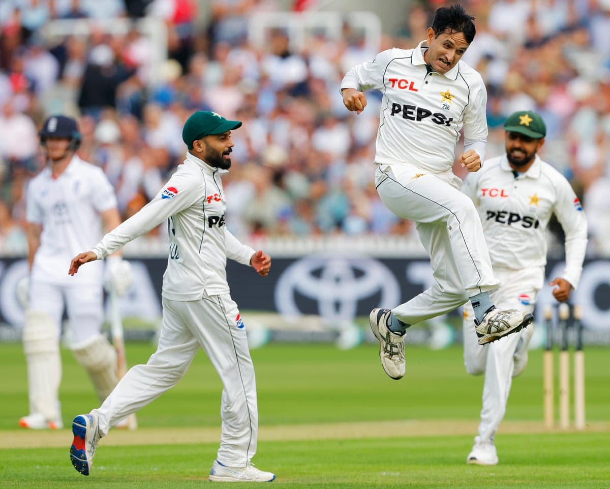 Muhammad Abbas leaps celebrating taking Joe Root's wicket as his Pakistan teammates run toward him