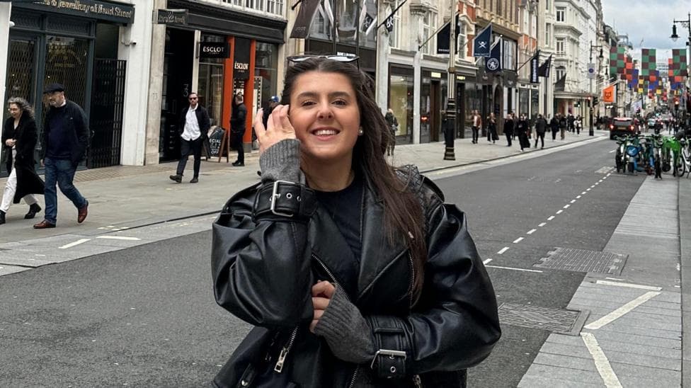 Ella Hewitt stands in a street