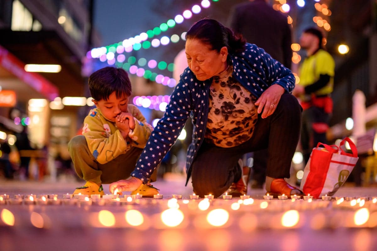 Mourners light candles