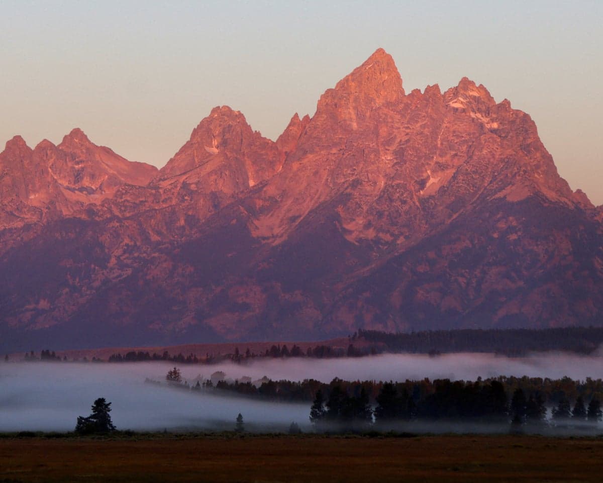 The sun rises on the Tetons in Jackson Hole, Wyoming