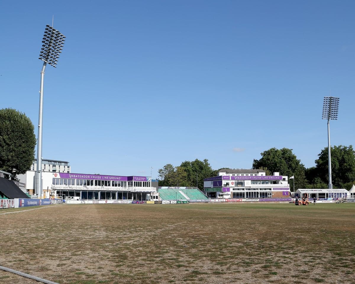 Empty cricket ground with pavilion buildings and floodlights at the Ambassador Cruise Line Ground