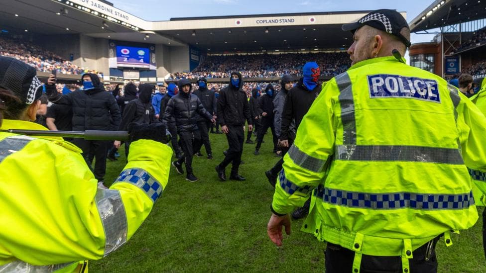 Rangers supporters confront police officers after last season's Scottish Cup quarter-final defeat by Celtic
