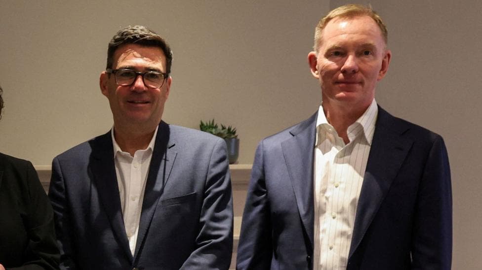 Andy Burnham and Sir Chris Bryant in blue suits with white shirts.