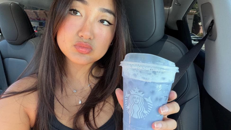 Elaine Ling holds a lavender Grande Ocean Drink from Starbucks