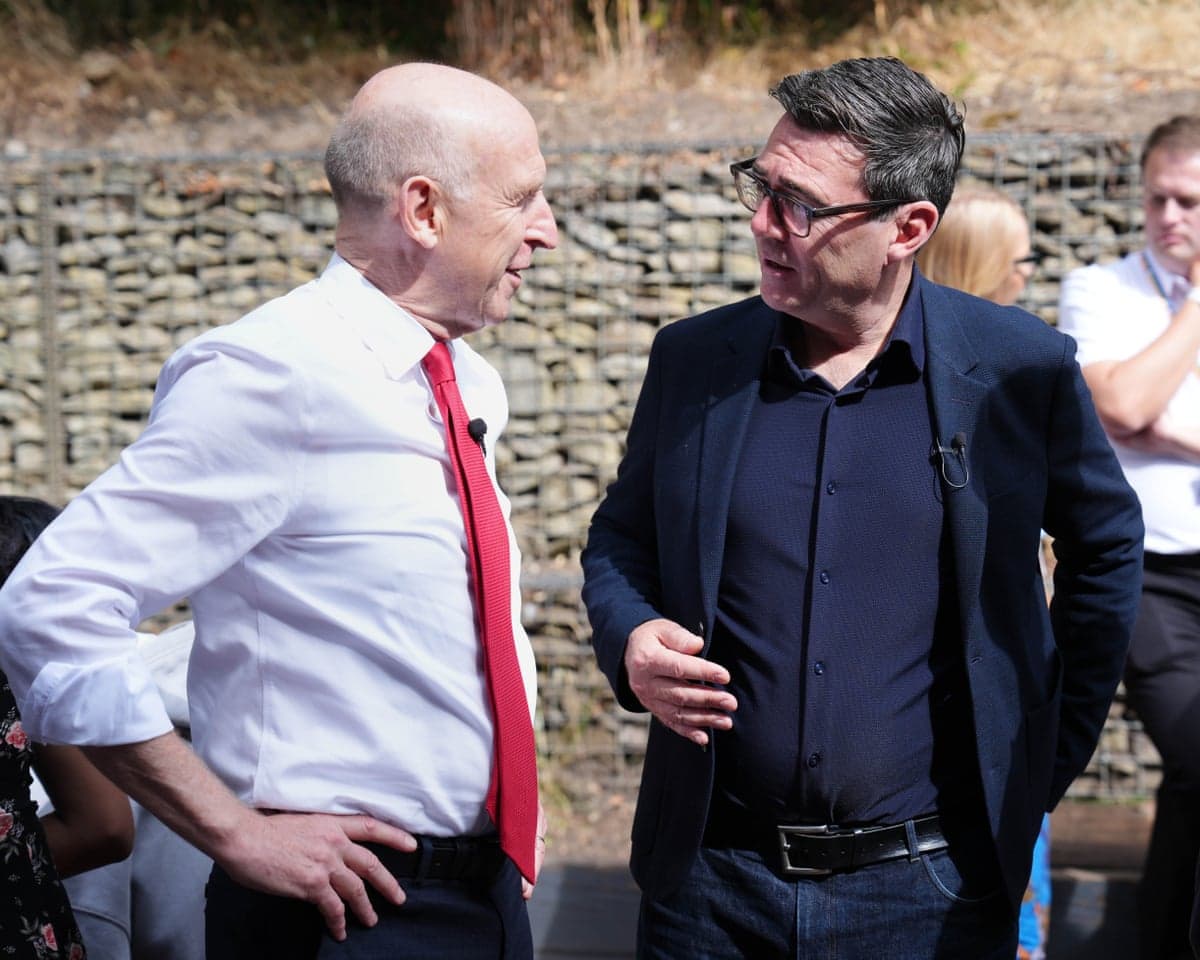 Andy Burnham speaks to John Healey in an outdoors area