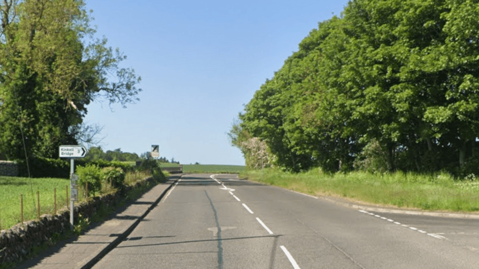 The A824, a country road with trees and grass verges