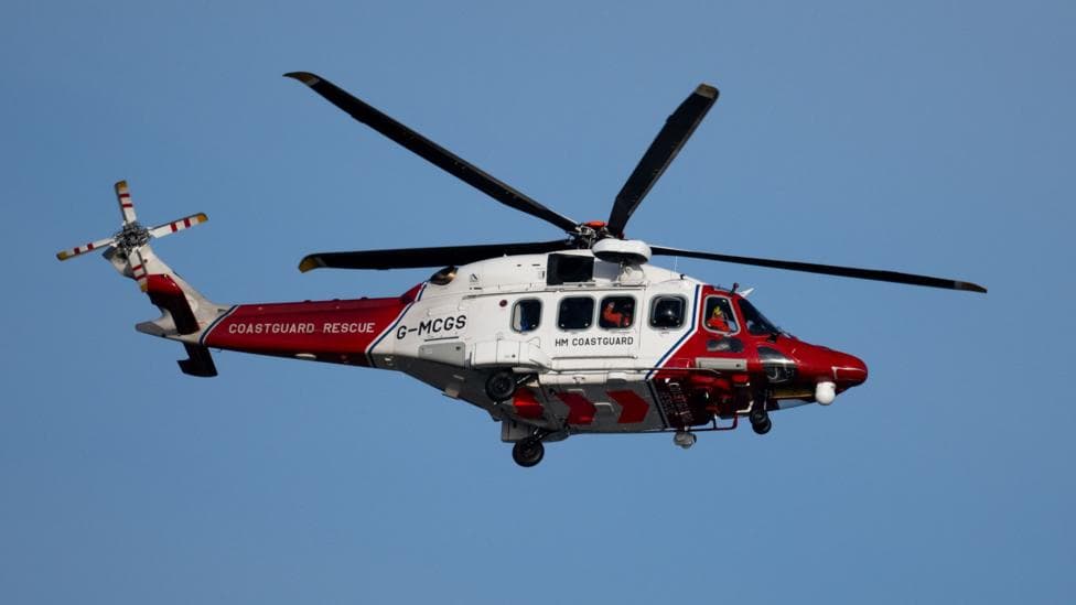 A coastguard helicopter in red and white livery