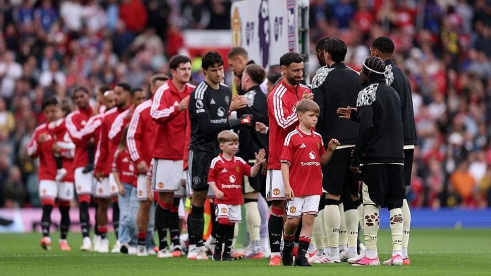 The sons of PC Matthew Blades join Bruno Fernandes in leading out Manchester United at Old Trafford. They are pictured shaking hands with Ipswich players