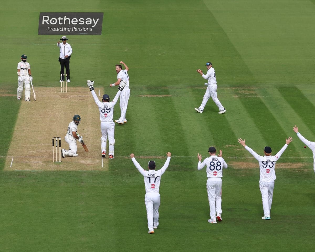 Ollie Robinson celebrates the wicket of Mohammad Rizwan with other England players