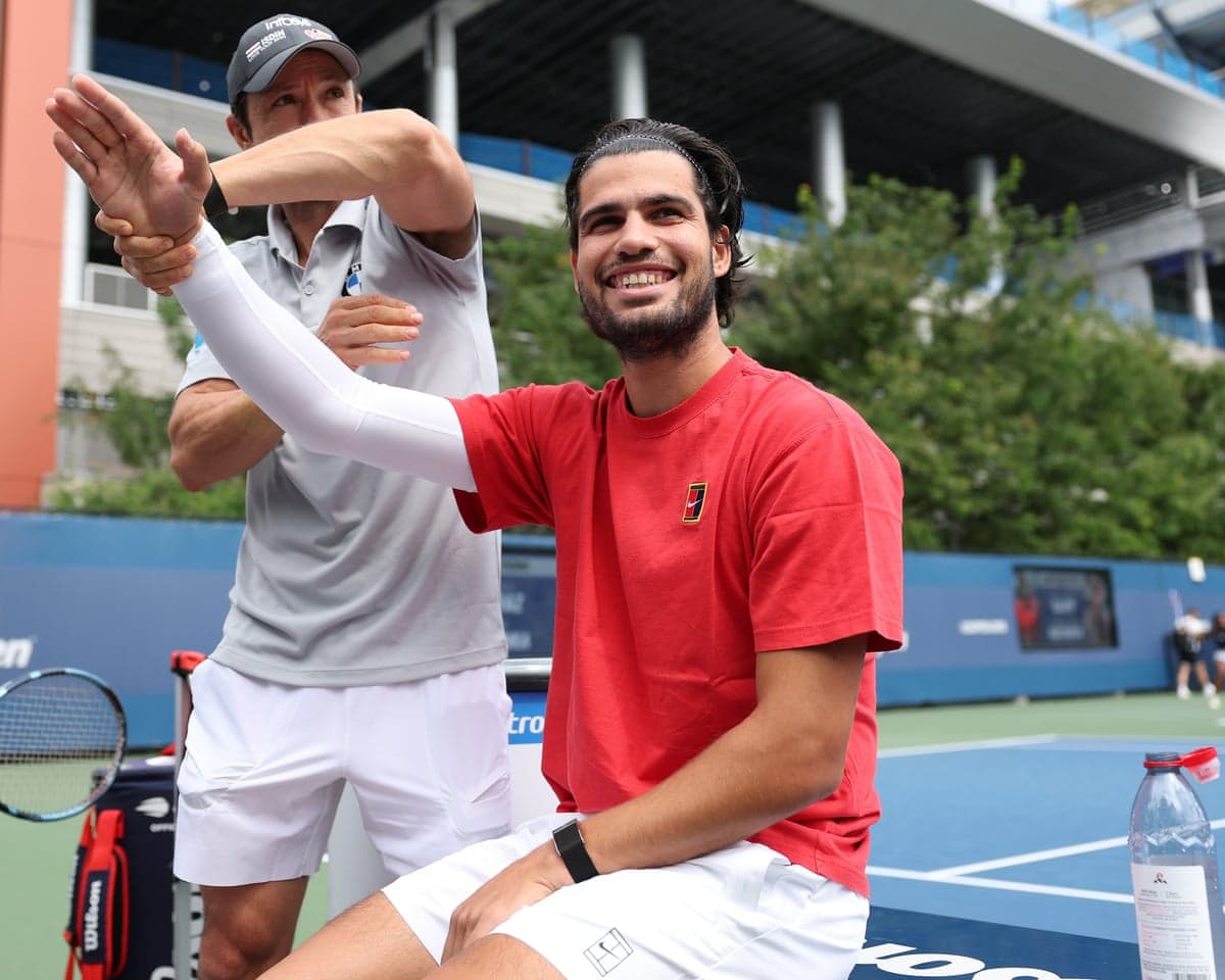 Carlos Alcaraz does wrist mobility exercises with his physio Juanjo Moreno