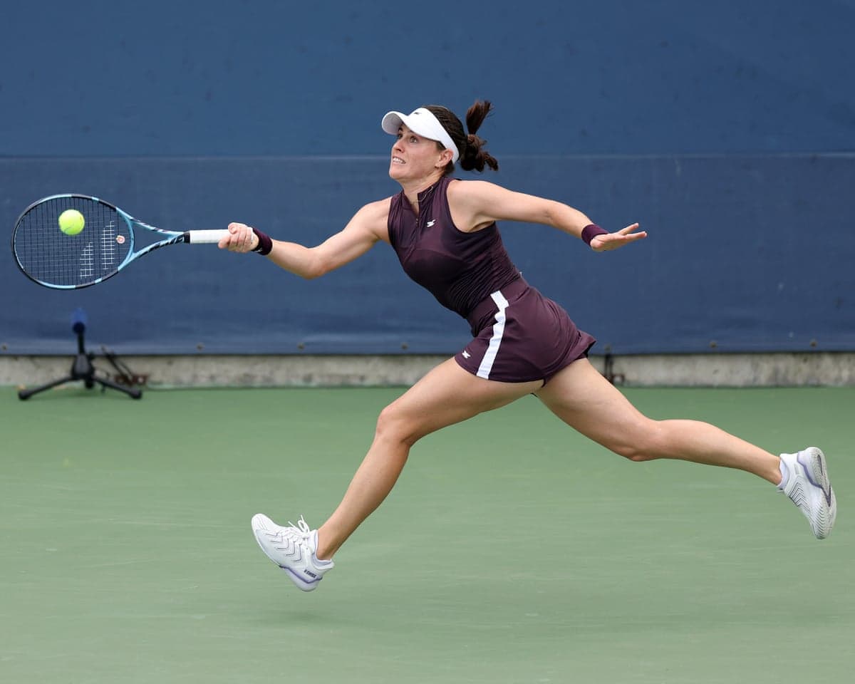 Kim Birrell stretches to returns a shot against Petra Marcinko during the women’s singles first round match at the US Open.