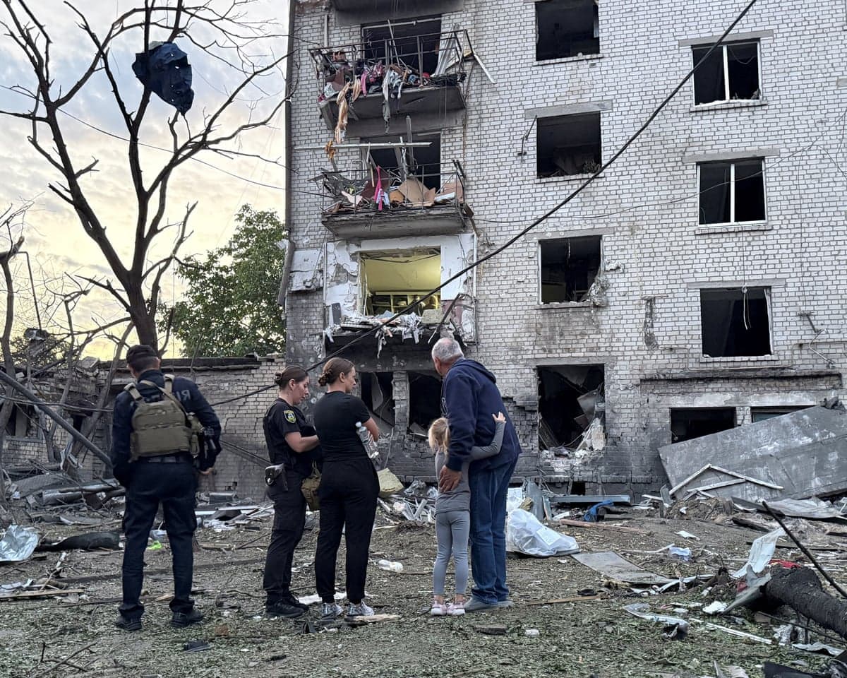 Police officers and residents stand at a site of an apartment building hit by a Russian missile strike, in the town of Borispil, Ukraine on 1 September , 2026.