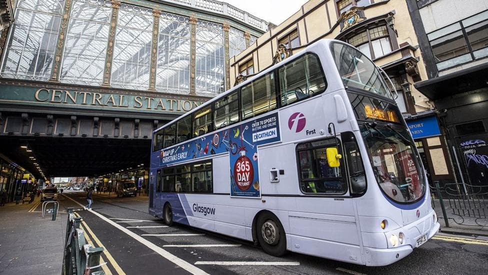 A First Bus driving under the bridge at Glasgow Central station