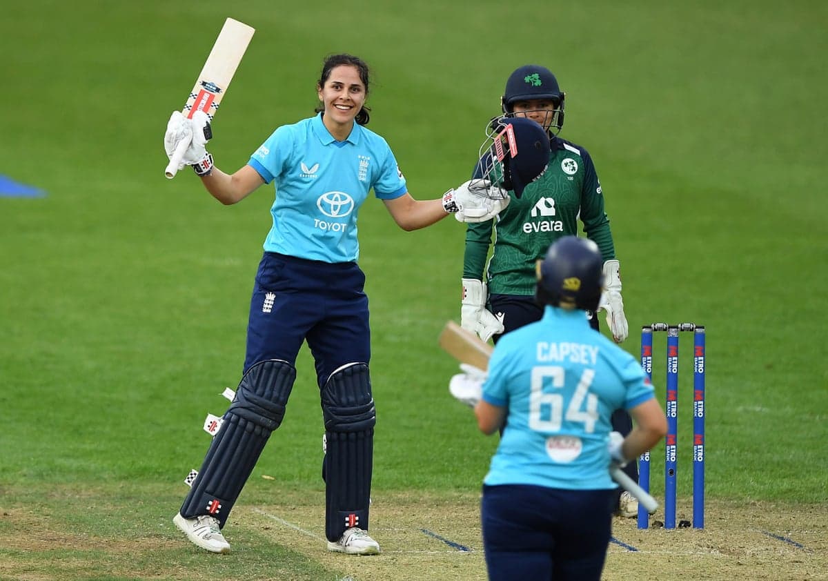 Maia Bouchier lifts her bat after reaching her century against Ireland