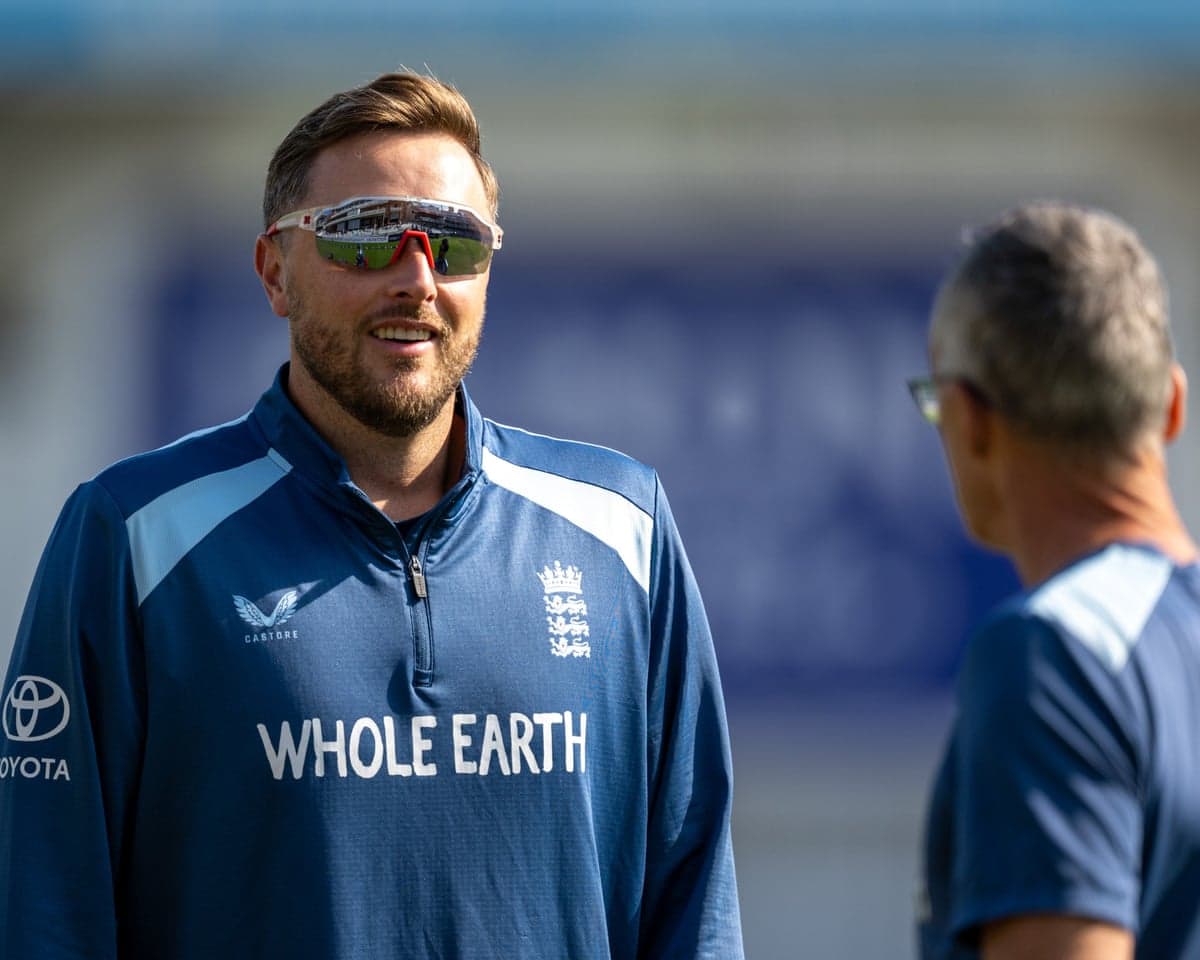 Ollie Robinson in sunglasses and navy England training kit
