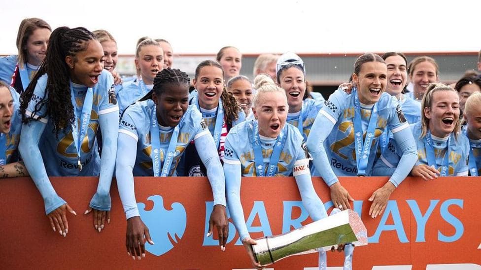 Manchester City captain Alex Greenwood holds the WSL trophy while her team-mates build excitement for lifting it