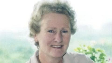 Doreen Morris wears beige and her hair has curls