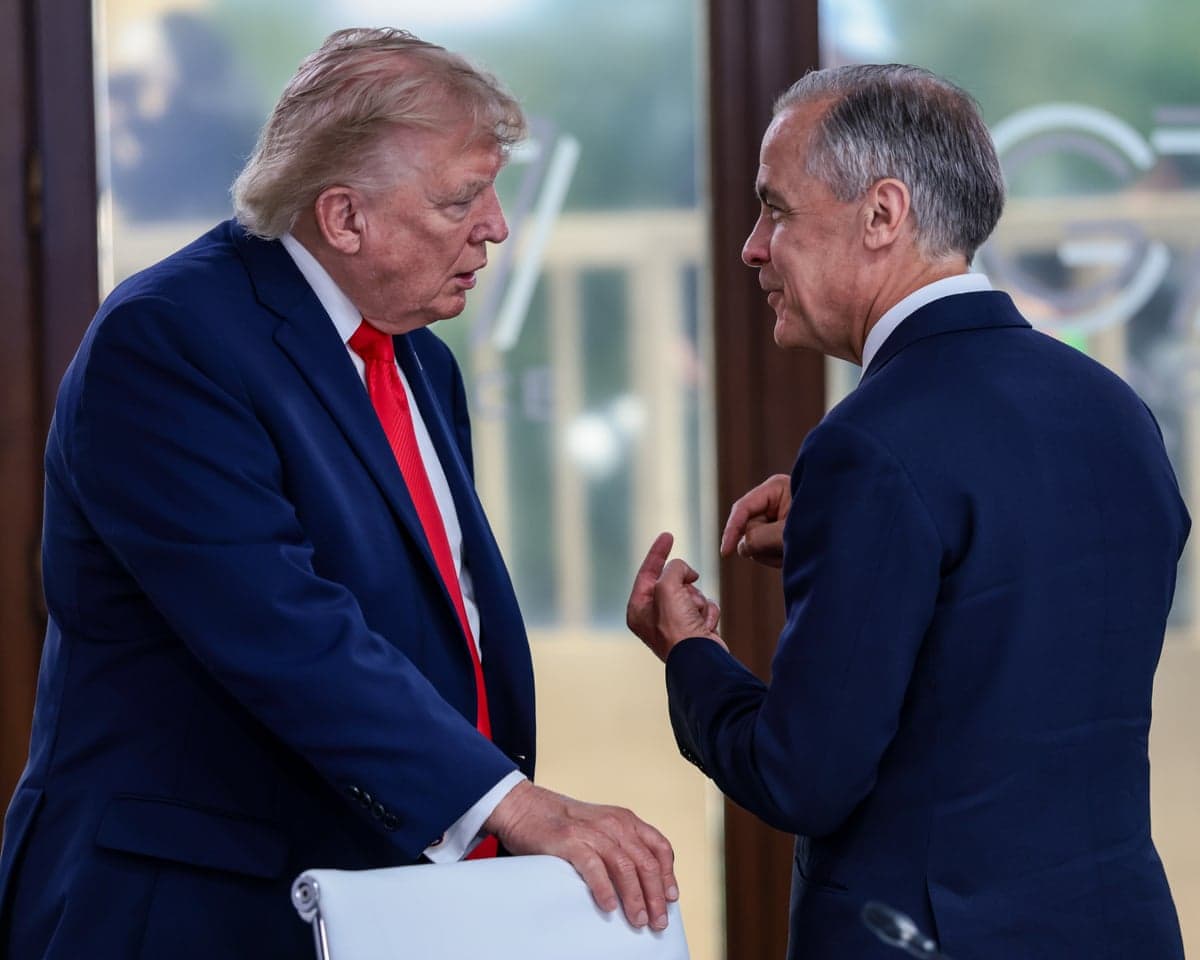 Trump and Canadian PM Mark Carney talk intently, Carney gesturing with his hands