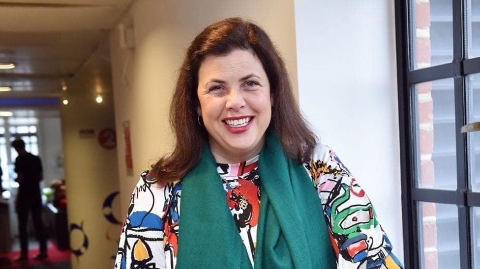 Kirsty Allsopp smiling at the camera while wearing a green chiffon scarf