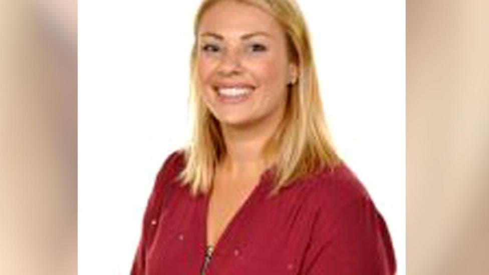 Posed headshot image of vicki williams wearing red blouse and smiling. She has long blonde hair