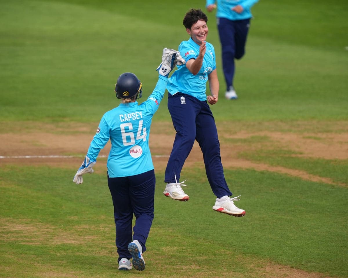 England's Issy Wong celebrates with teammate Alice Capsey after removing Gaby Lewis