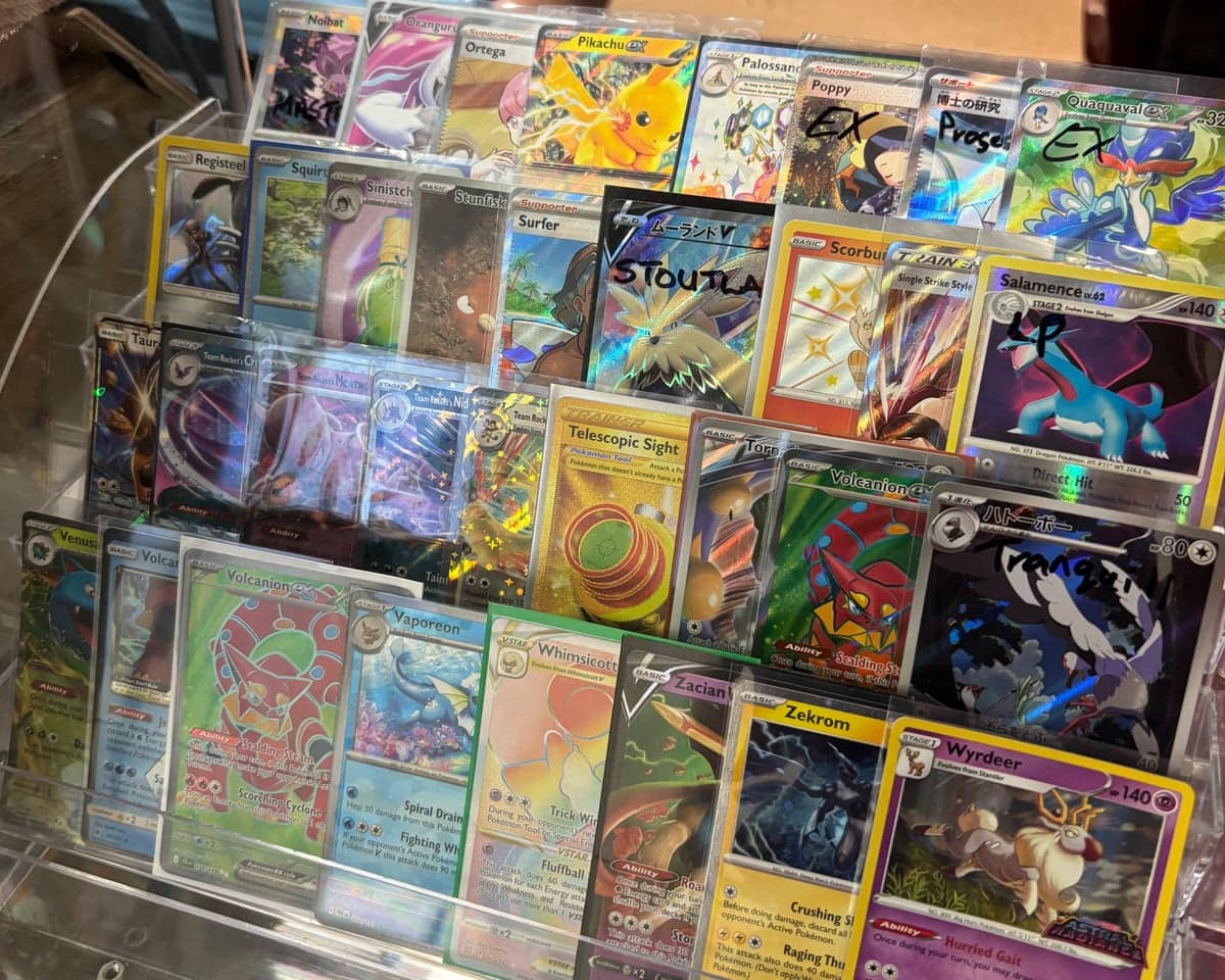 Single Pokémon cards for sale, locked in a cabinet.