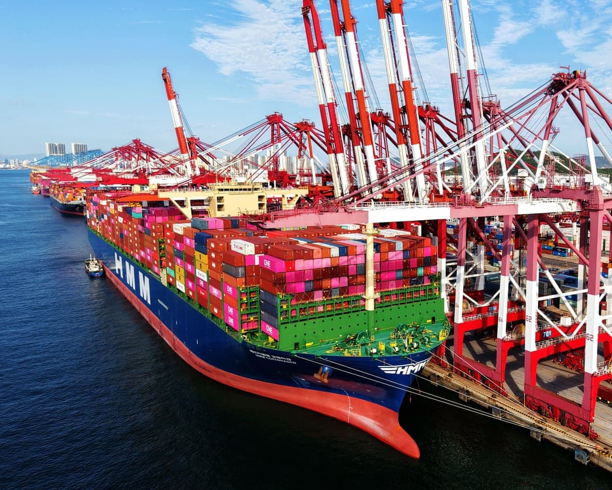 A cargo ship is loaded and unloaded with containers.