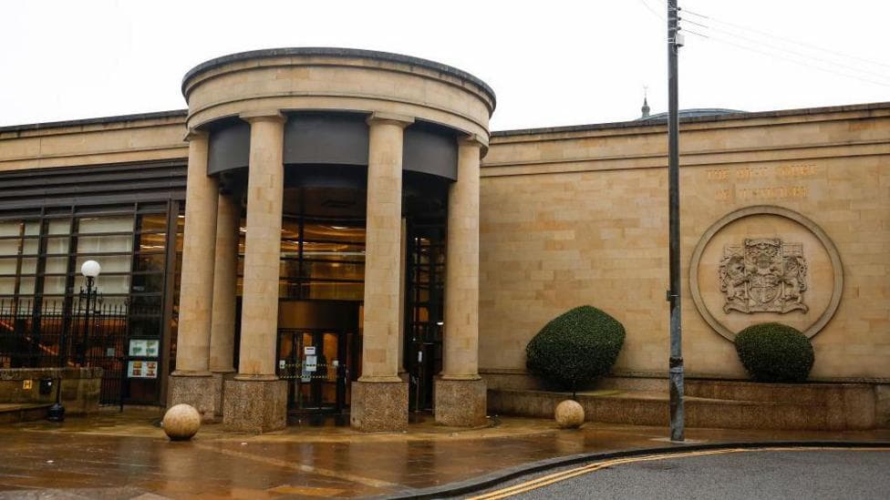 High Court in Glasgow - a sandstone building with columns at the front forming a circular entrance
