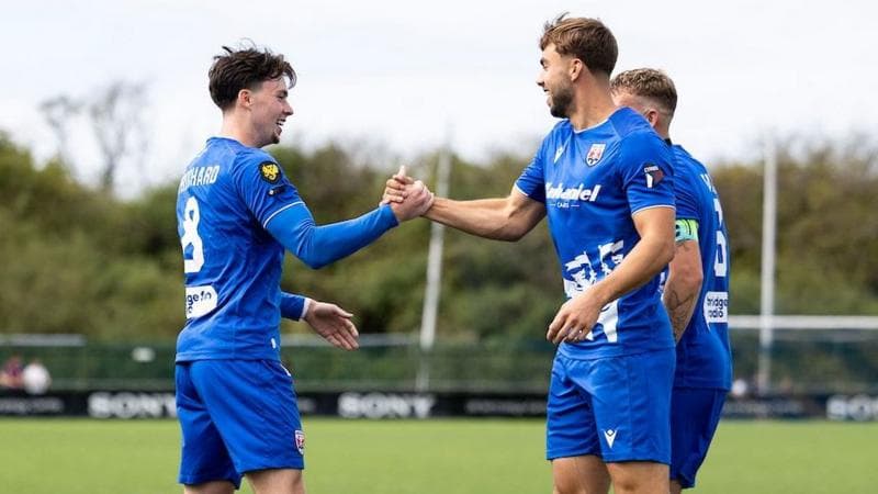 Owain Pritchard celebrates with Penybont team-mates after scoring