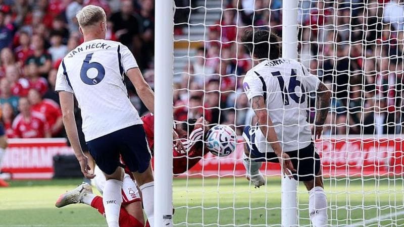 Nottingham Forest defender Neco Williams bundles the ball into the Tottenham net