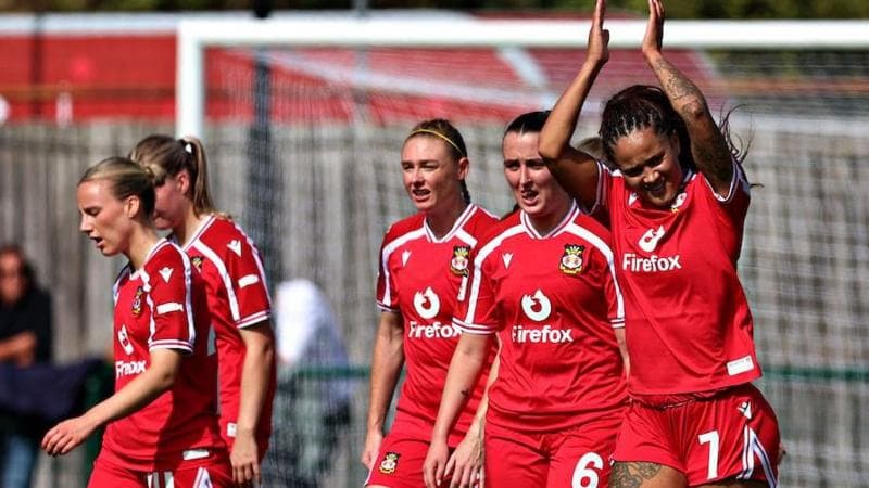 Natasha Thomas applauds supporters after scoring for Wrexham