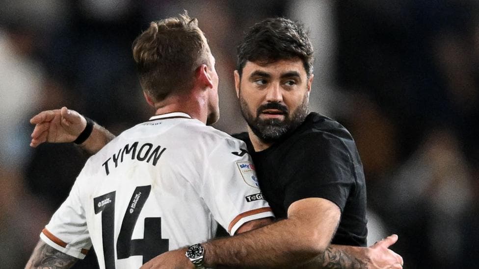 Swansea boss Vitor Matos hugs defender Josh Tymon