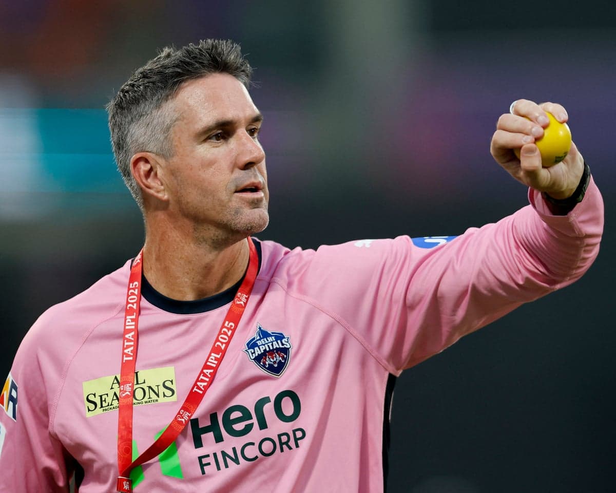 Kevin Pietersen, in a pink Delhi Capitals jersey, holds up a yellow ball.