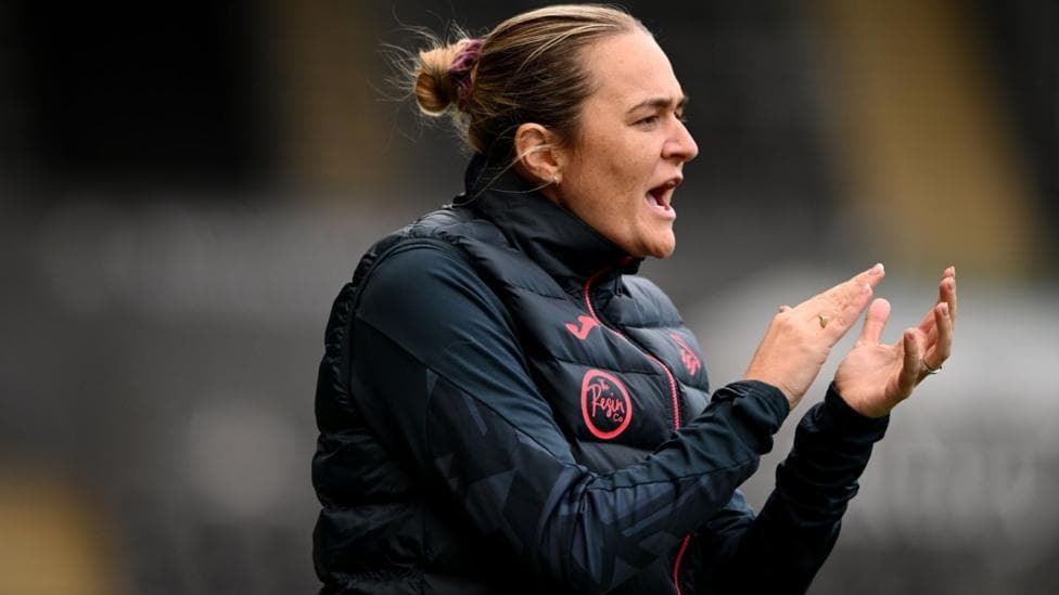 Swansea manager Yzzy Taylor applauds on the touchline
