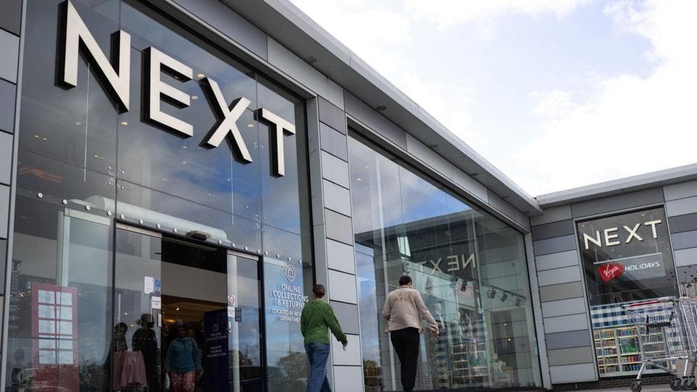 A next storefront with people outside it.