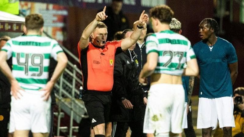 Referee John Beaton signals for a penalty after reviewing the incident