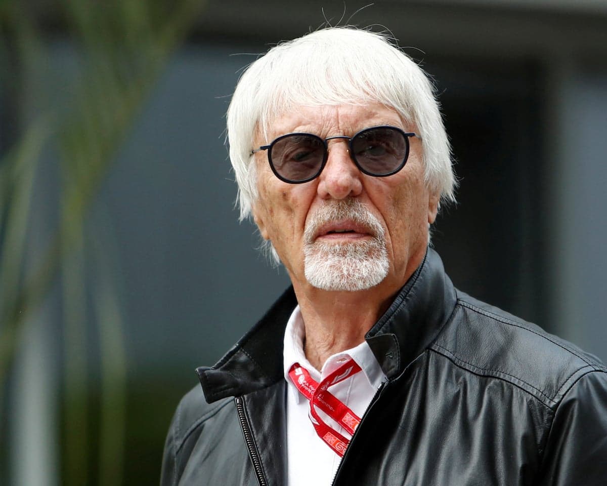 Bernie Eccletone in black jacket, sunglasses and white shirt