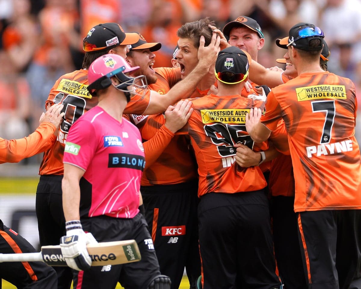 Aaron Hardie of the Scorchers is congratulated by teammates after dismissing Steve Smith of the Sixers
