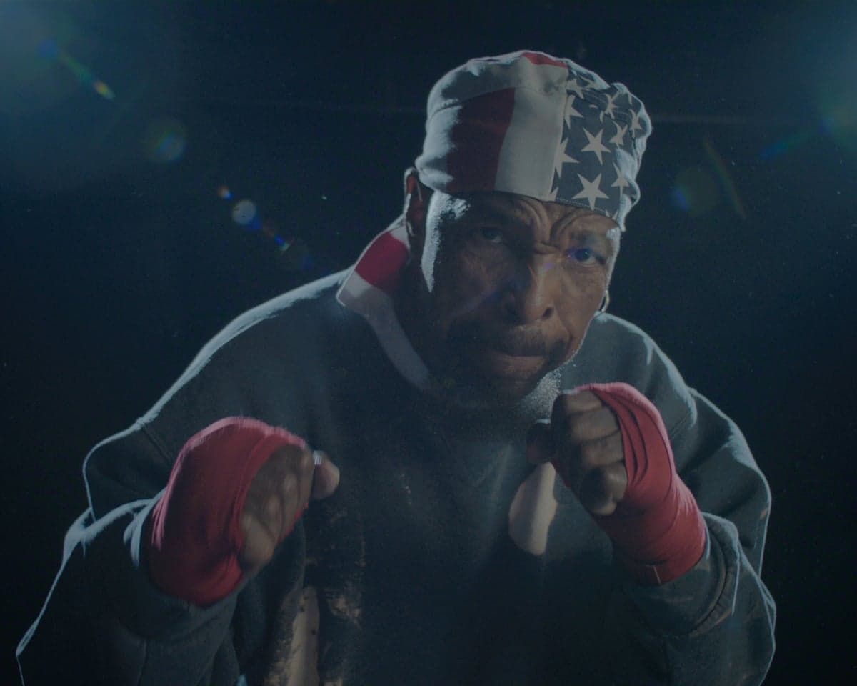 Mr T wears a US-flag bandana and pretends to box the camera