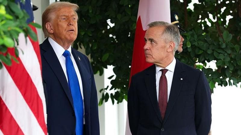 US President Donald Trump speaks to Canadian Prime Minister Mark Carney during a welcome outside the West Wing of the White House in October 2025